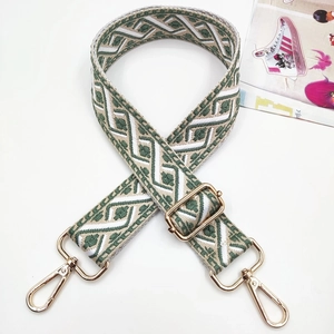 Close-up of bohemian geometric jacquard bag strap with polished gold metal swivel hooks