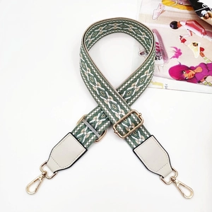 Close-up of green floral jacquard bag strap with white leather and gold metal clips