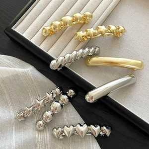 Elegant gold and silver minimalist geometric hair clips set in star and heart shapes