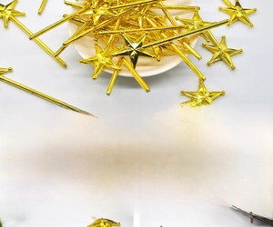 Detailed close-up of golden electroplated plastic star wands for DIY party decorations