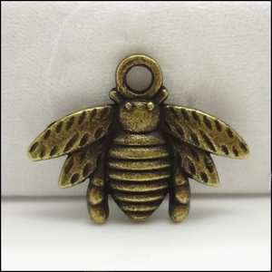 Detailed macro view of an antique bronze bee shaped alloy charm for DIY jewelry making