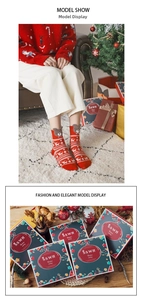 Detailed view of red Christmas stockings with reindeer patterns and 3D bear design