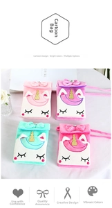 Detail view of plush unicorn crossbody bags in pink, purple, green, and rose colors