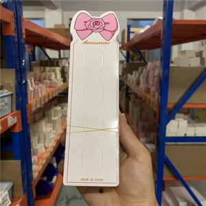 Pink ribbon design long paper card holder for hair clips with four pre-cut slots