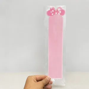 Detailed view of pink hairpin display card with bow design in warehouse setting
