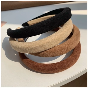 Three minimalist faux suede headbands in black, beige, and brown for elegant hair styling