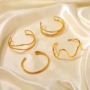 Set of 18k gold plated stainless steel open bracelets with elegant wave and layered designs