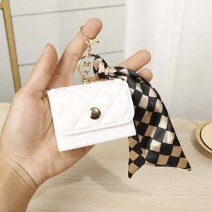 Mini quilted coin purse in creamy white with gold buckle and checkered silk scarf