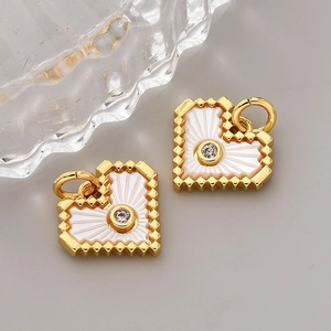 Macro shot of heart-shaped 18K gold-plated shell pendant with a centered zircon stone