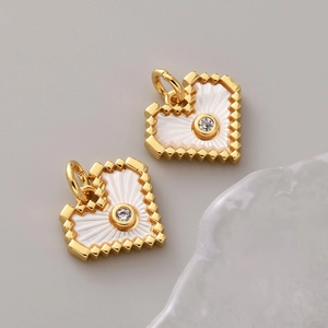 Macro view of pixelated heart pendant in 18K gold plating with central zircon stone