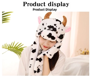 Close-up of soft cow-themed plush hat with ears and horns shown on model