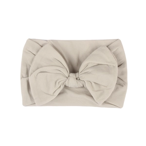 Soft nylon baby headband with a large beige bow, comfortable accessory for infants
