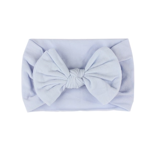 Soft nylon baby headband with a large light blue fabric bow for newborns and infants