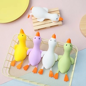 Set of colorful cartoon duck stress relief squeeze toys in a decorative basket