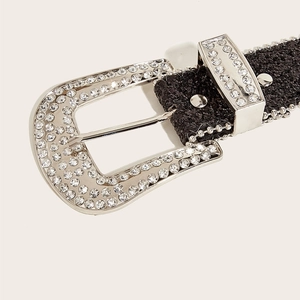 Close-up of Y2K black glitter belt featuring a large silver buckle with sparkling rhinestones