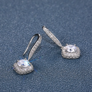 Macro shot of silver drop earrings with a round zircon and micro-pave crystals