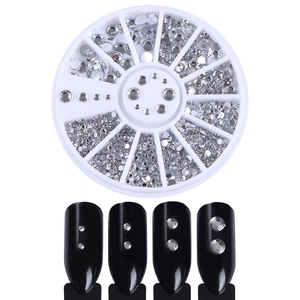Detail of round nail art rhinestones in a white wheel case with black display tips