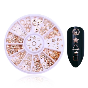 Macro detail of rose gold nail art charms in a pink organizer box with nail demonstration