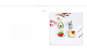 Macro detail of cartoon zinc alloy pins including avocado and coffee cup designs