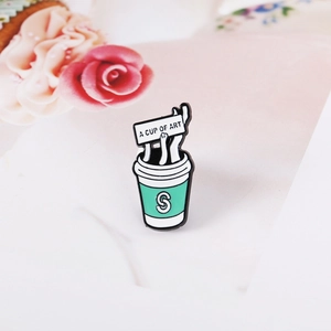 Detail of cute cat coffee enamel pin featuring A Cup of Art text on pink background