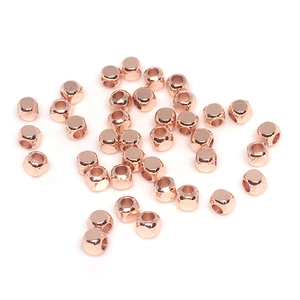 Macro shot of 14K rose gold filled square cube beads with smooth metallic finish