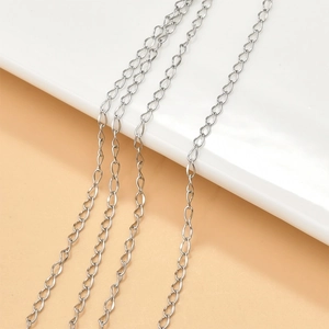 Detailed view of silver O-chain and curb chain extensions for DIY jewelry making