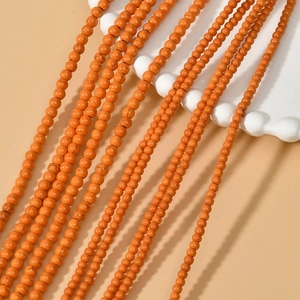 Macro shot of 3mm orange turquoise round spacer beads for DIY jewelry making