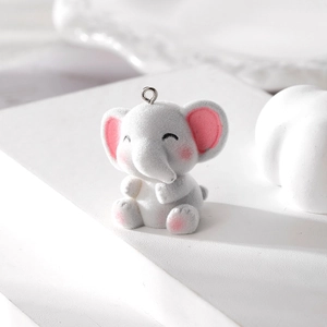 Detail view of a cute grey flocked elephant pendant with a metal ring for DIY jewelry making