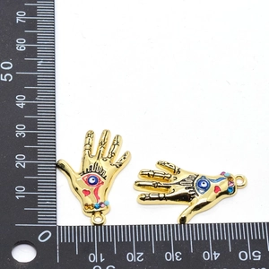 Evil Eye and Hamsa Hand pendant with colored rhinestones on a white scale background