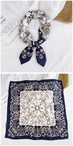Close-up of Baroque pattern silk scarf with vintage floral design and glossy texture