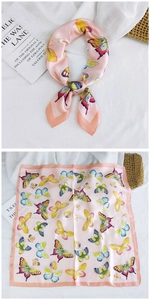Detailed views of pink silk scarf with butterfly print and smooth satin texture