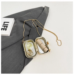 Detail of gold metal lipstick clutch with built-in mirror and slim chain strap