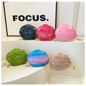 Selection of acrylic marble shell bags in various vibrant colors with gold chain straps