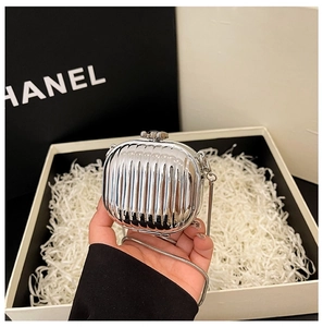 Close-up of silver mini acrylic hard shell bag with vertical stripes and chain strap