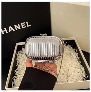 Detail of silver mirror mini clutch bag with ribbed texture and metal snake chain