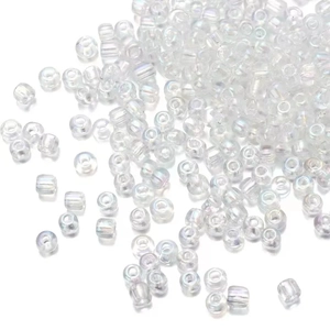 Macro shot of 2mm clear phantom glass seed beads scattered on a white surface
