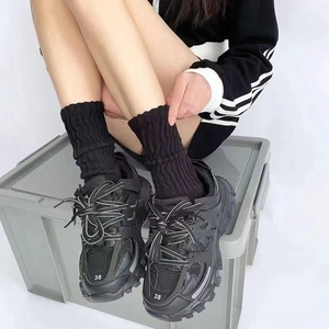 Classic black layered chunky sneakers with matching long socks and size 38 toe detail