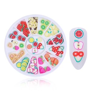Detailed view of colorful fruit nail art slices with 12-slot storage box on a white base