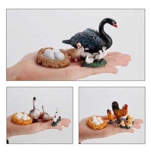 Detailed close-up of miniature black swan family and poultry farm animal figurines