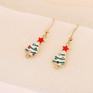 Detail of Christmas tree earrings with white enamel and colorful rhinestones