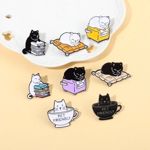 Set of 8 colorful metal enamel cat badges featuring cute pets interacting with books