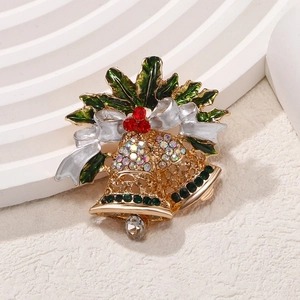 Christmas gold bell brooch with green holly leaves and white enamel bow accessory