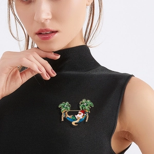 Christmas brooch with Santa in a hammock between palm trees and sparkling rhinestones