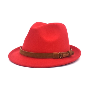 Detailed side view of a red wool fedora hat with a brown decorative buckle belt