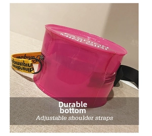 Close-up of pink transparent round crossbody bag with adjustable strap and fashion text