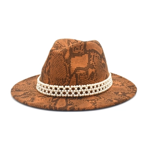 Close-up of brown snake print fedora hat featuring three rows of white faux pearl trim