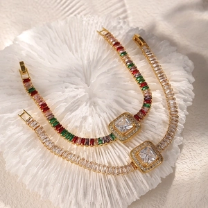 Elegant gold bracelet featuring square colorful zircons on white coral texture background