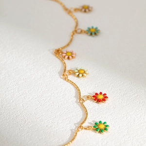 Gold chain necklace with colorful enamel daisy pendants in red, green, blue and pink