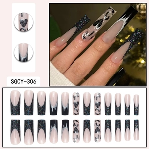 Long coffin press-on nails with black glitter French tips, heart and moon patterns