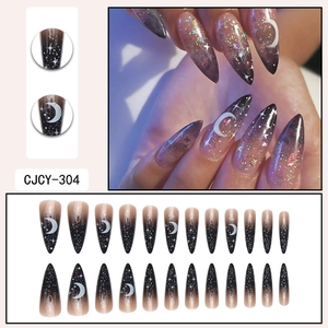 Long stiletto press on nails featuring black white gradient with stars and moon patterns